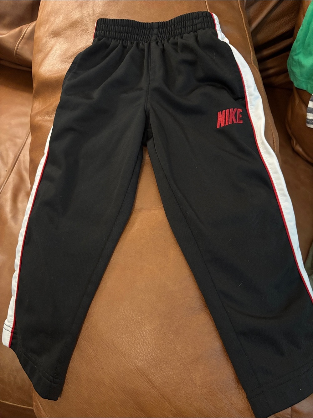 Nike Kids Black Joggers with Red Logo and White Side Panels